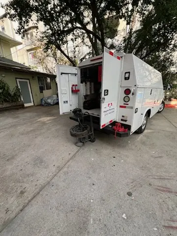 Magnet Plumbing service vehicle on-site for Grease Trap Cleaning in Miracle Mile